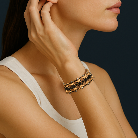 Handwoven cuff-style bracelet with black and gold beads in a geometric crescent pattern, shown on a wrist