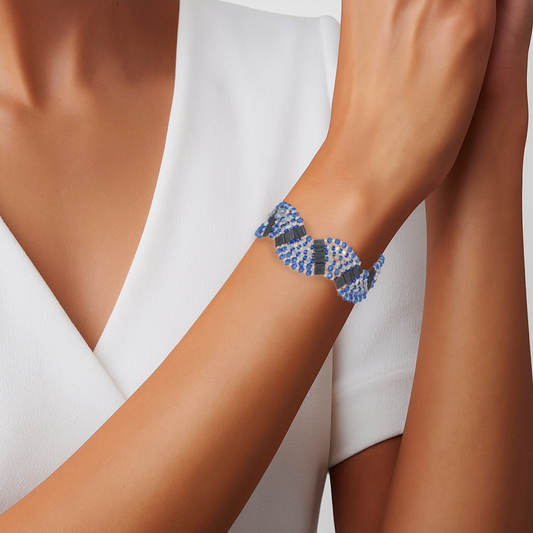 Bracelet handwoven with sapphire blue and silver crystal beads in a geometric pattern, on a wrist
