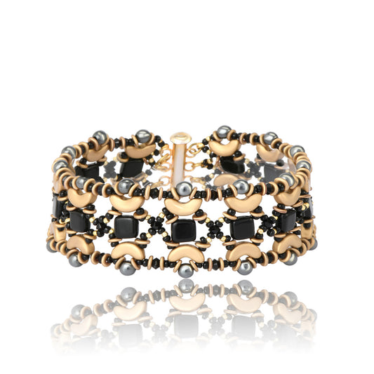 Handwoven cuff-style bracelet with black and gold beads in a geometric crescent pattern, shown on white background